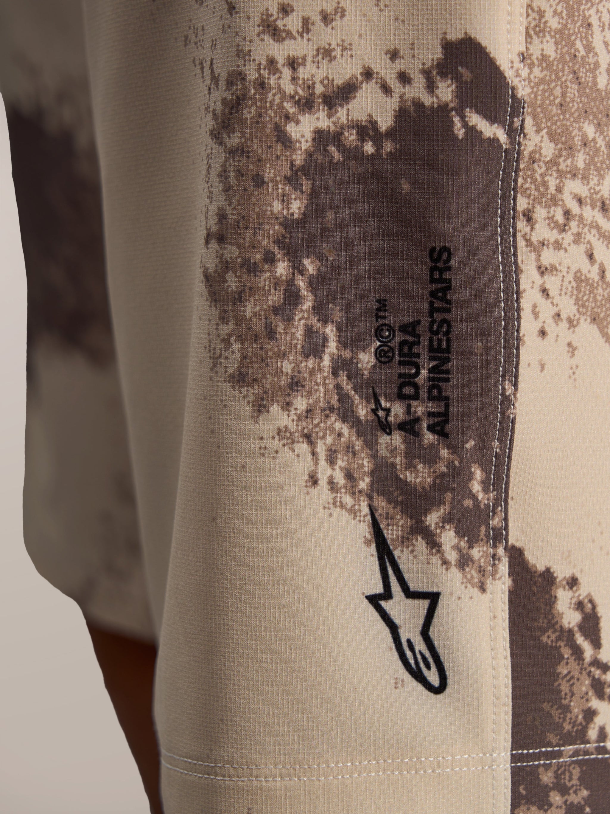 A-Dura Ride Shorts in sand camo, featuring the Astar logo on durable 4-way stretch technical woven fabric.