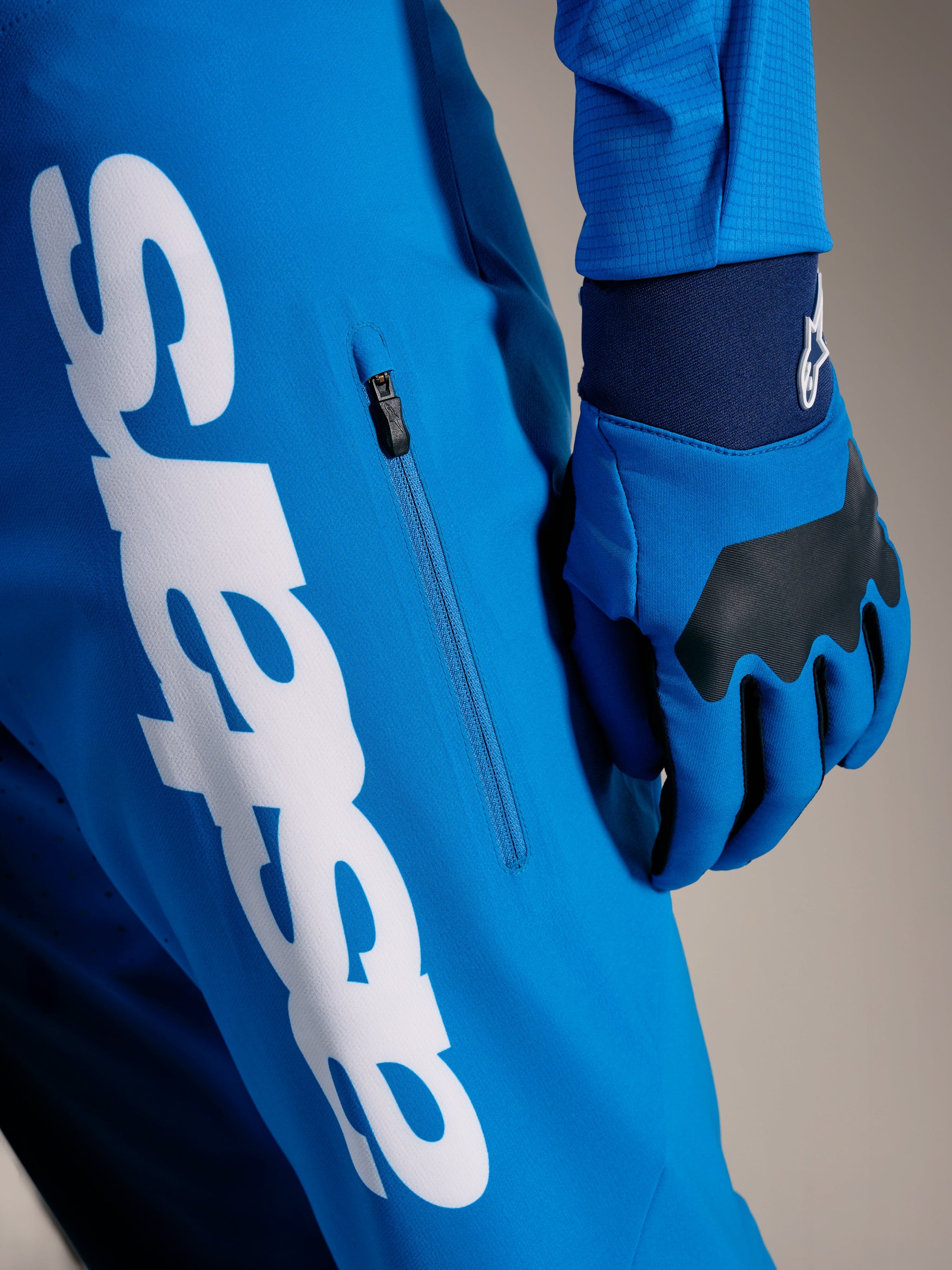 Faded Bright Blue A-Supra Elite MTB Pants featuring a large white Astars wordmark and vertical zippered side pocket.