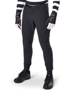 Alpinestars A-Aria Elite Pants, Black Mountain Bike Pants, featuring laser-cut ventilation on thighs and magnetic buckle closure, worn with black and white striped jersey and gloves, performance MTB gear for off-road cycling