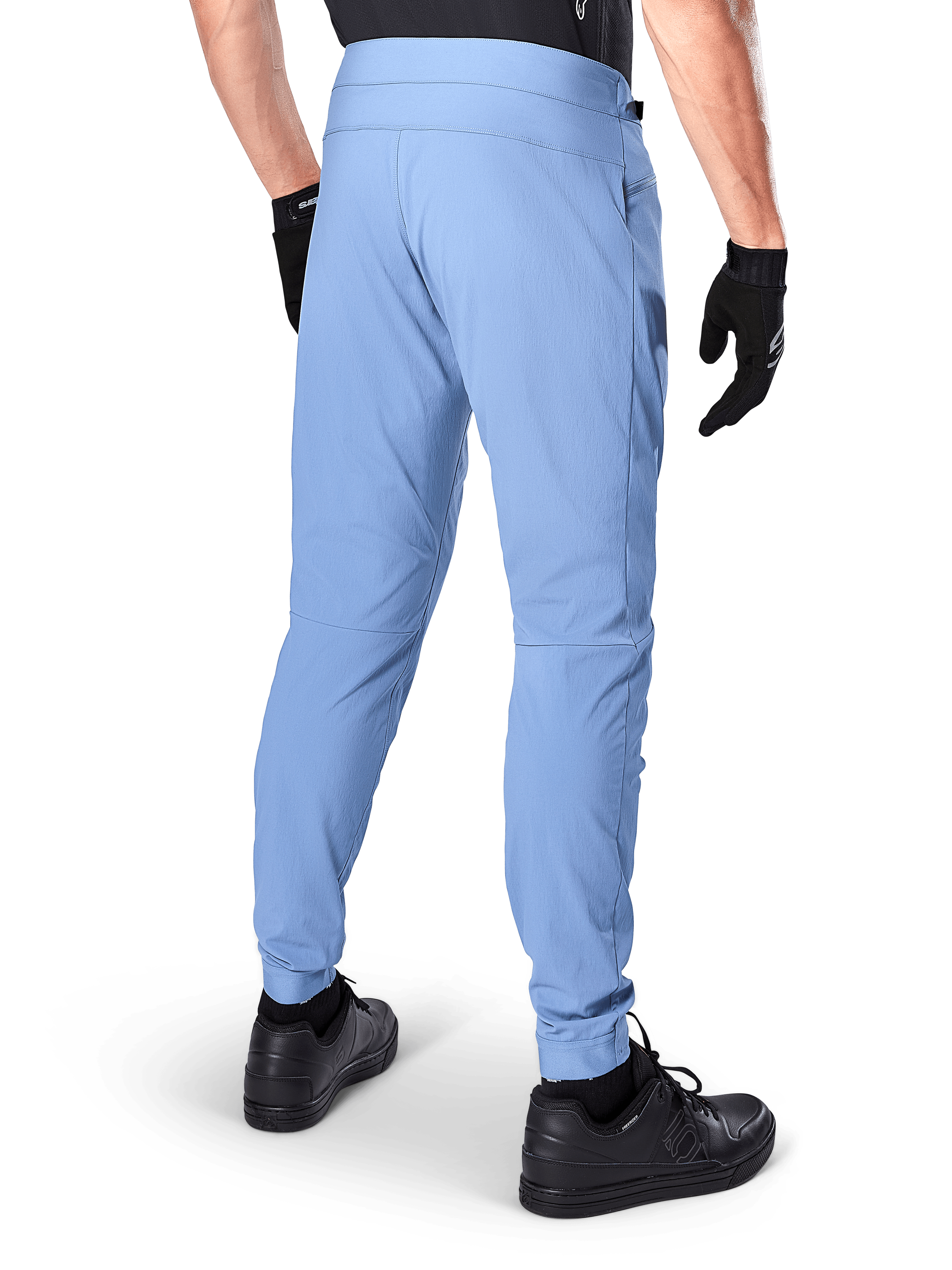 Alpinestars A-Dura Pants, Mountain Bike Pants, Infinity Blue, back view showing regular fit and elasticated cuffs, worn with black gloves and black footwear, durable 2-way stretch cycling apparel.
