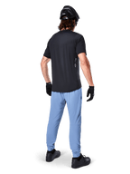 Alpinestars A-Dura Pants, MTB Pants, Infinity Blue, rear view on model wearing a black t-shirt and black cycling helmet, featuring durable 2-way stretch fabric and elasticated cuffs, performance gear for mountain biking