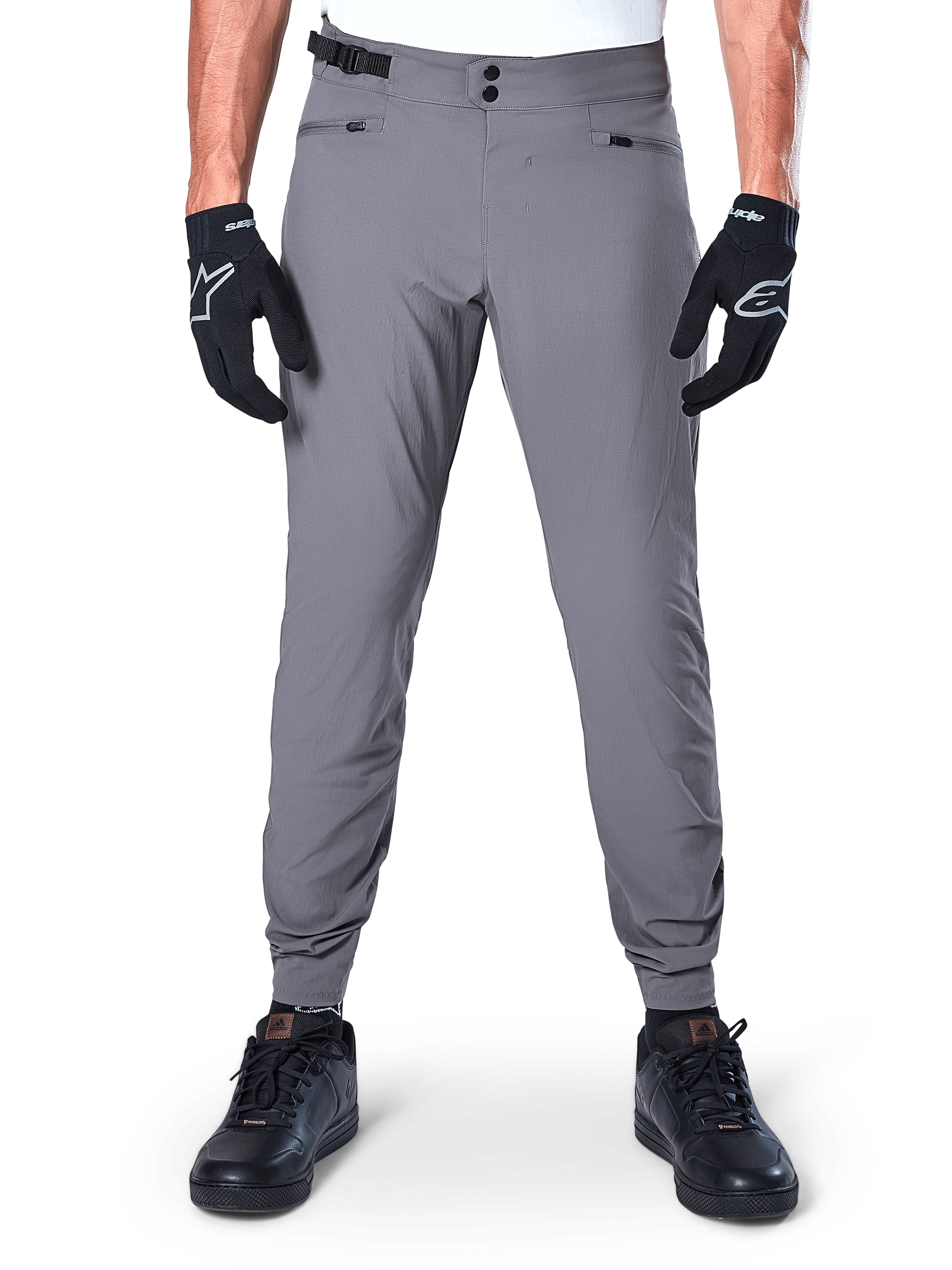 Alpinestars A-Dura Pants, Dark Gray Mountain Bike Pants, front view worn with black gloves and black sneakers, featuring double snap waist closure, zippered hand pockets, and elasticated cuffs, durable cycling apparel for trail riding