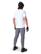 Alpinestars A-Dura Pants, Dark Gray Mountain Bike Pants shown from the back, worn with a white short-sleeve t-shirt, black MTB helmet, black gloves and shoes, regular fit design with elasticated cuffs, durable off-road cycling gear
