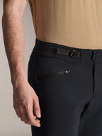 Alpinestars A-Dura Shorts, Black MTB shorts, close-up view showing zippered pocket and adjustable side cinch strap, double snap closure, durable fabric for mountain biking