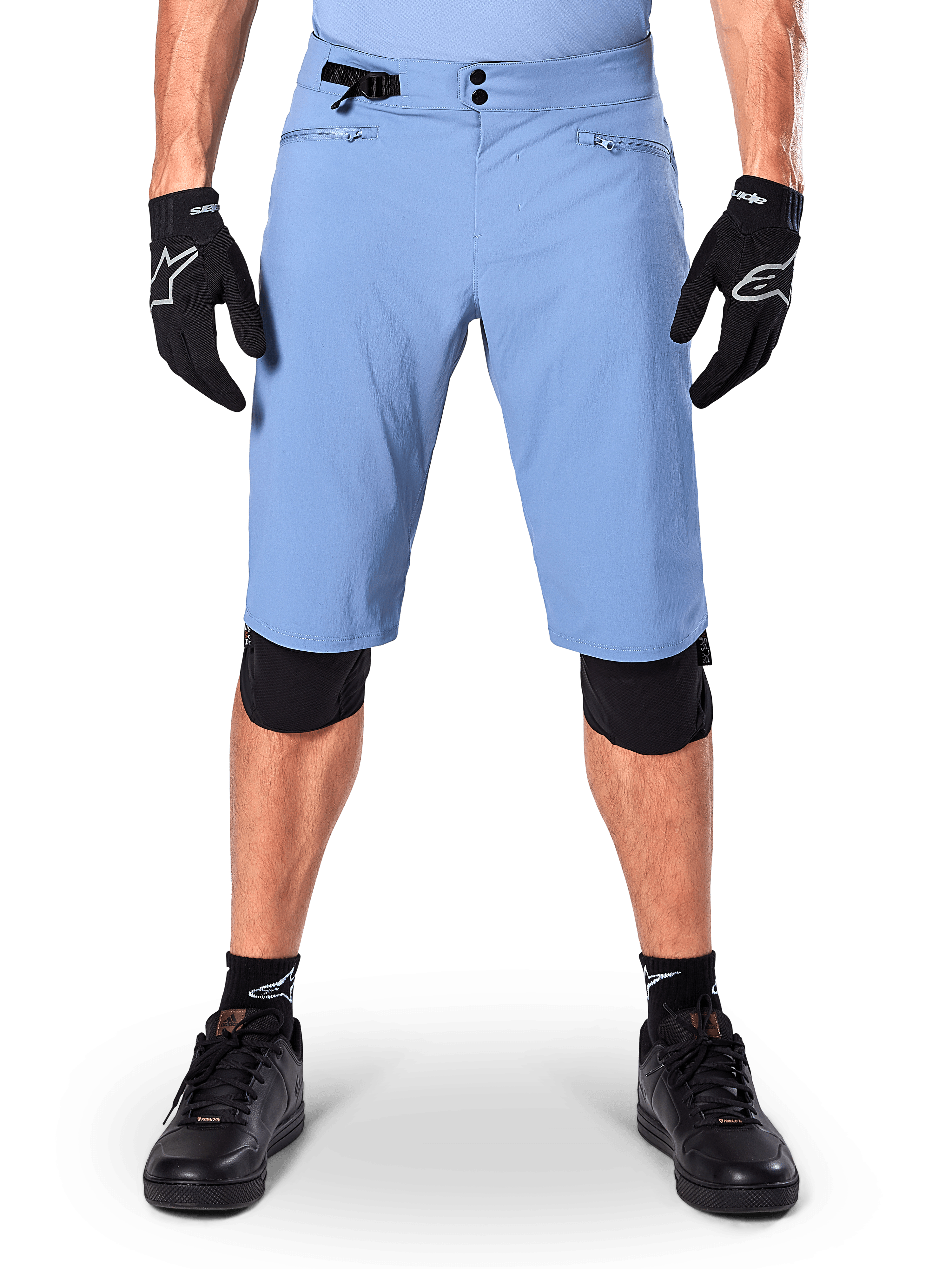 Alpinestars A-Dura Shorts, Infinity Blue mountain bike shorts, worn with black gloves and knee pads, featuring a double snap closure and side waist adjuster, performance cycling gear for MTB
