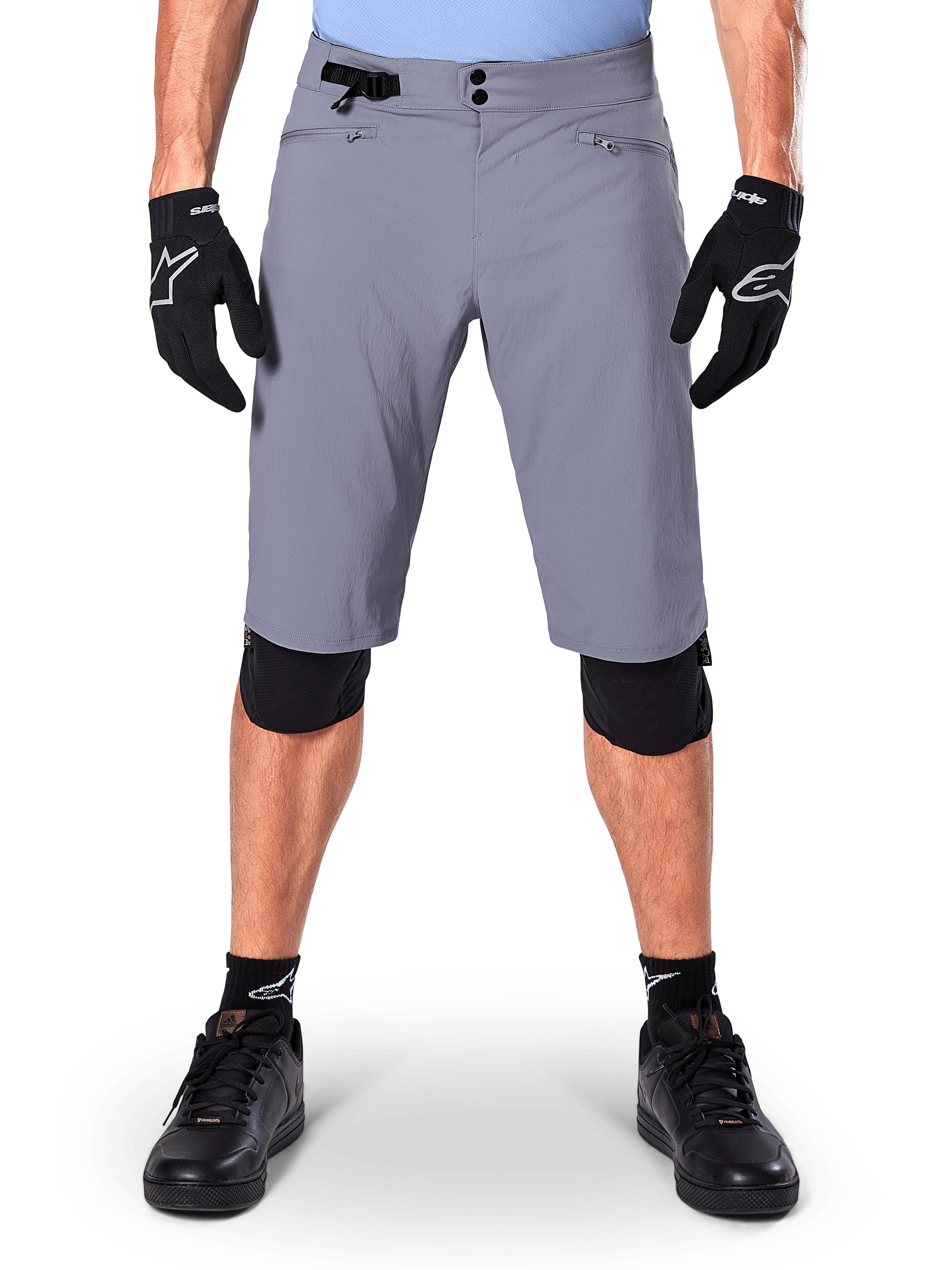 Alpinestars A-Dura Shorts, Mountain Bike Shorts, Dark Gray, worn with black Alpinestars gloves and knee pads, featuring double snap closure and zippered mesh-lined pockets, durable 2-way stretch fabric for off-road cycling