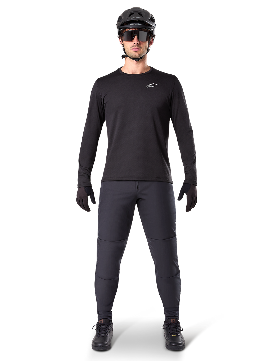 Alpinestars A-Dura Thermal Jersey, Black long-sleeve mountain bike jersey, worn with dark grey pants, black gloves, black helmet and sunglasses, featuring a white Alpinestars logo on the chest, coordinated outfit for cold-weather mountain biking
