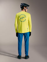 A-Dura Air Long Sleeve Jersey in Yellow Fluo featuring blue Racing Ahead circular back graphic and mountain bike gear.