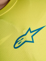Yellow Fluo A-Dura Air Jersey detail with blue Alpinestars logo on breathable mesh fabric for mountain biking.