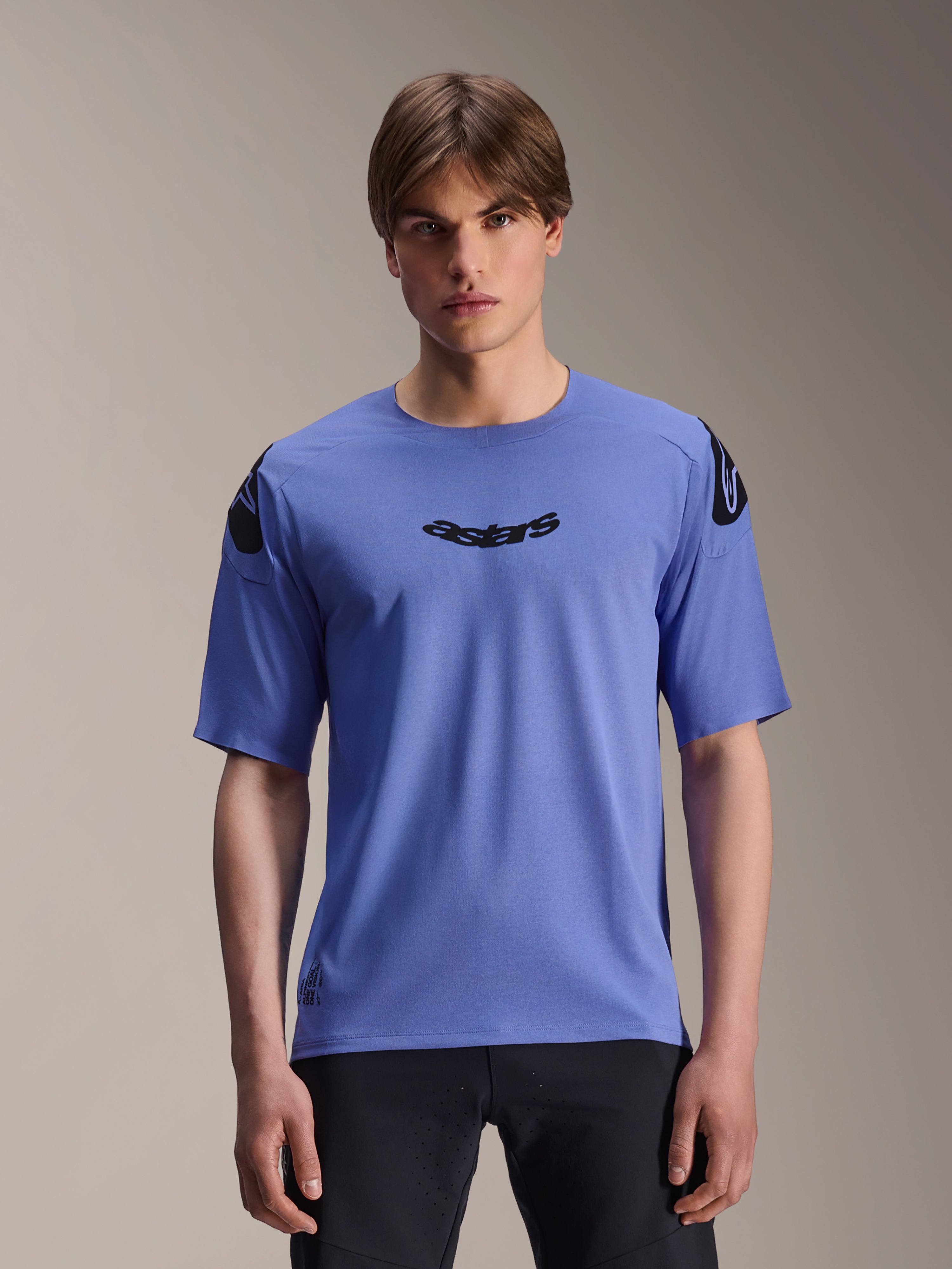 Alpinestars A-Aria Polartec Elite Jersey, Short Sleeve MTB Jersey, Baja Blue, worn by a male model, featuring black 'astars' wordmark on the chest and shoulder logos, performance trail riding apparel.