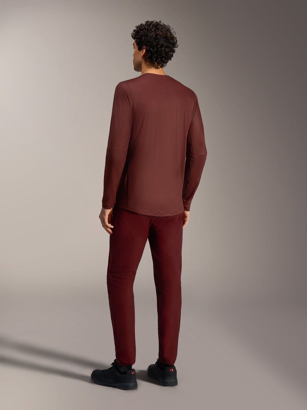 A-Dura Ride Long Sleeve Jersey in Bordeaux, rear view, breathable jacquard MTB gear with an extended drop tail design.