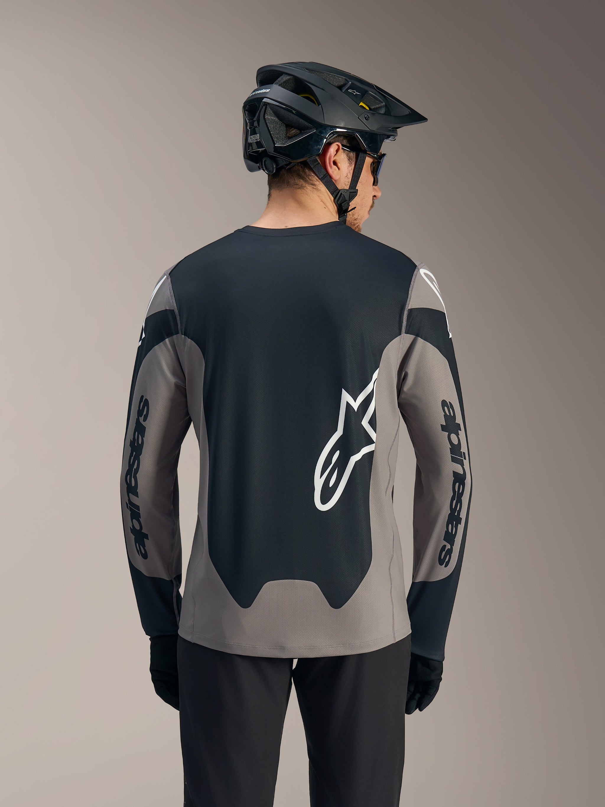 A-Dura Race Long Sleeve Jersey in gray and black, featuring bold white Alpinestars logos on the back and sleeves.