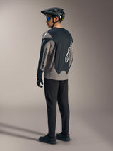 Gray and black A-Dura Race Long Sleeve Jersey, featuring Alpinestars branding, shown from behind in a full MTB kit.