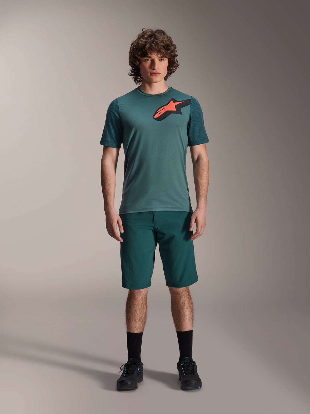 Alpinestars A-Dura Lipan Jersey, Short Sleeve MTB Jersey, Silver Pine green with black and orange Astars logo on chest, paired with matching shorts and black footwear, technical mountain bike apparel