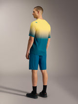 A-Dura ASTARS 2.0 Short Sleeve MTB Jersey in yellow and teal gradient, paired with matching blue performance shorts.