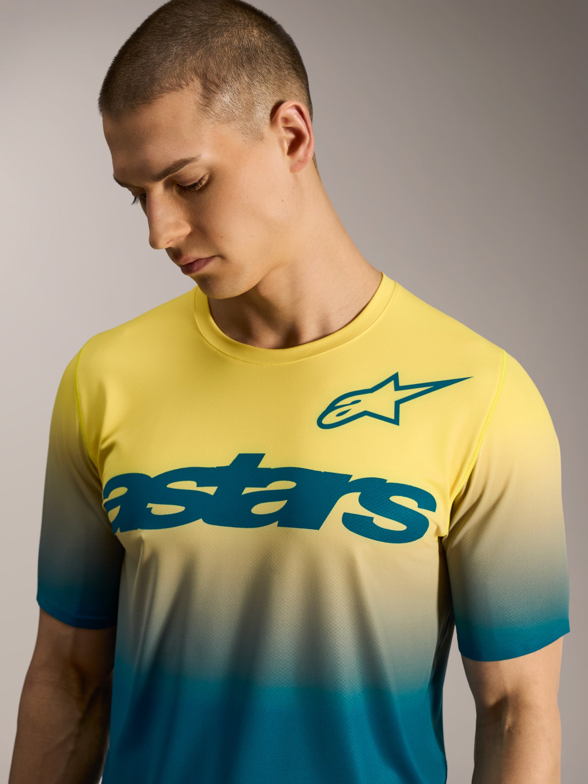 A-Dura ASTARS Jersey 2.0, yellow and blue gradient short sleeve MTB shirt featuring bold chest wordmark and star logo.