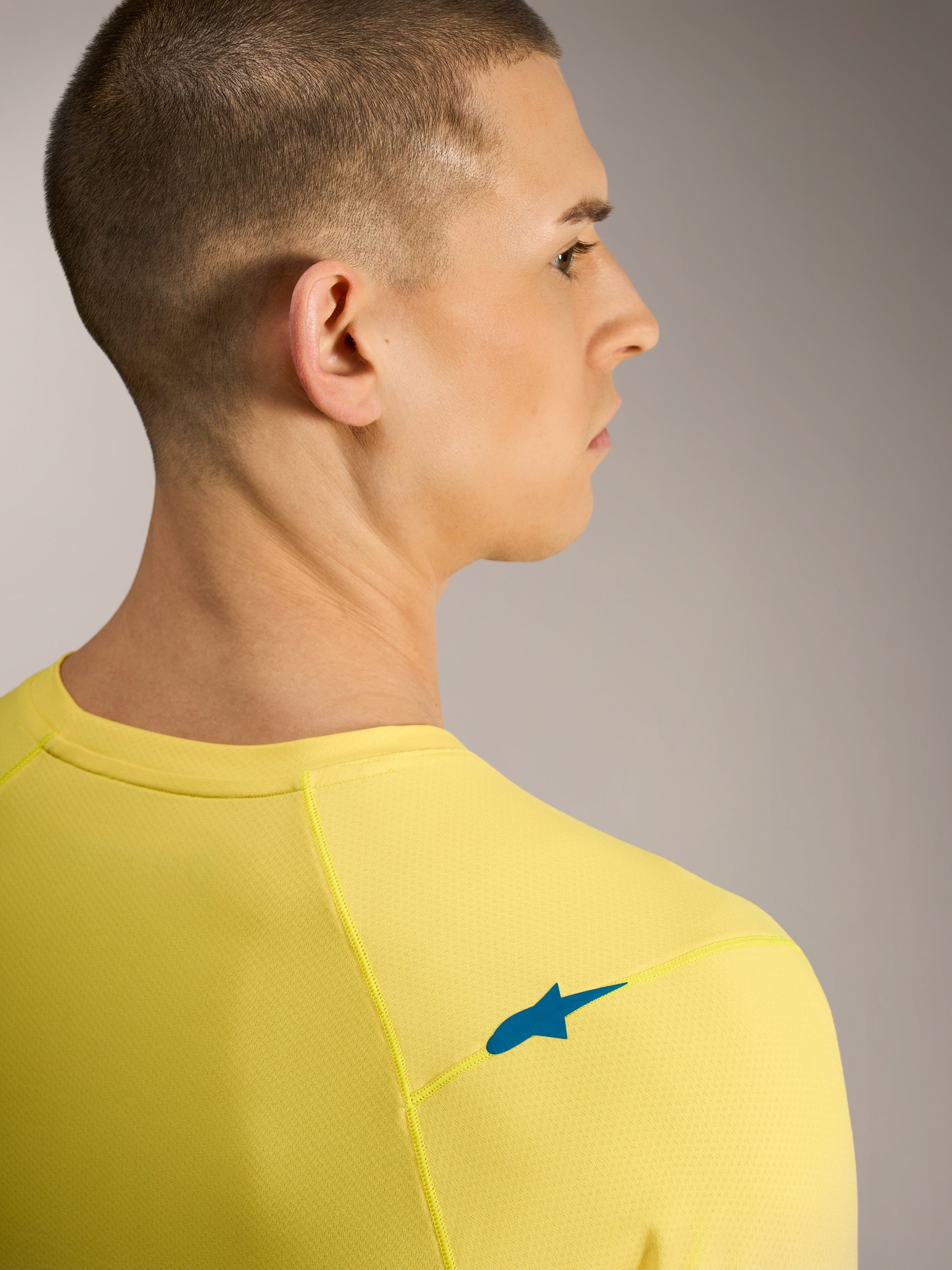 Yellow fluo A-Dura ASTARS Jersey 2.0, back view showing blue shoulder logo and breathable jacquard MTB fabric.