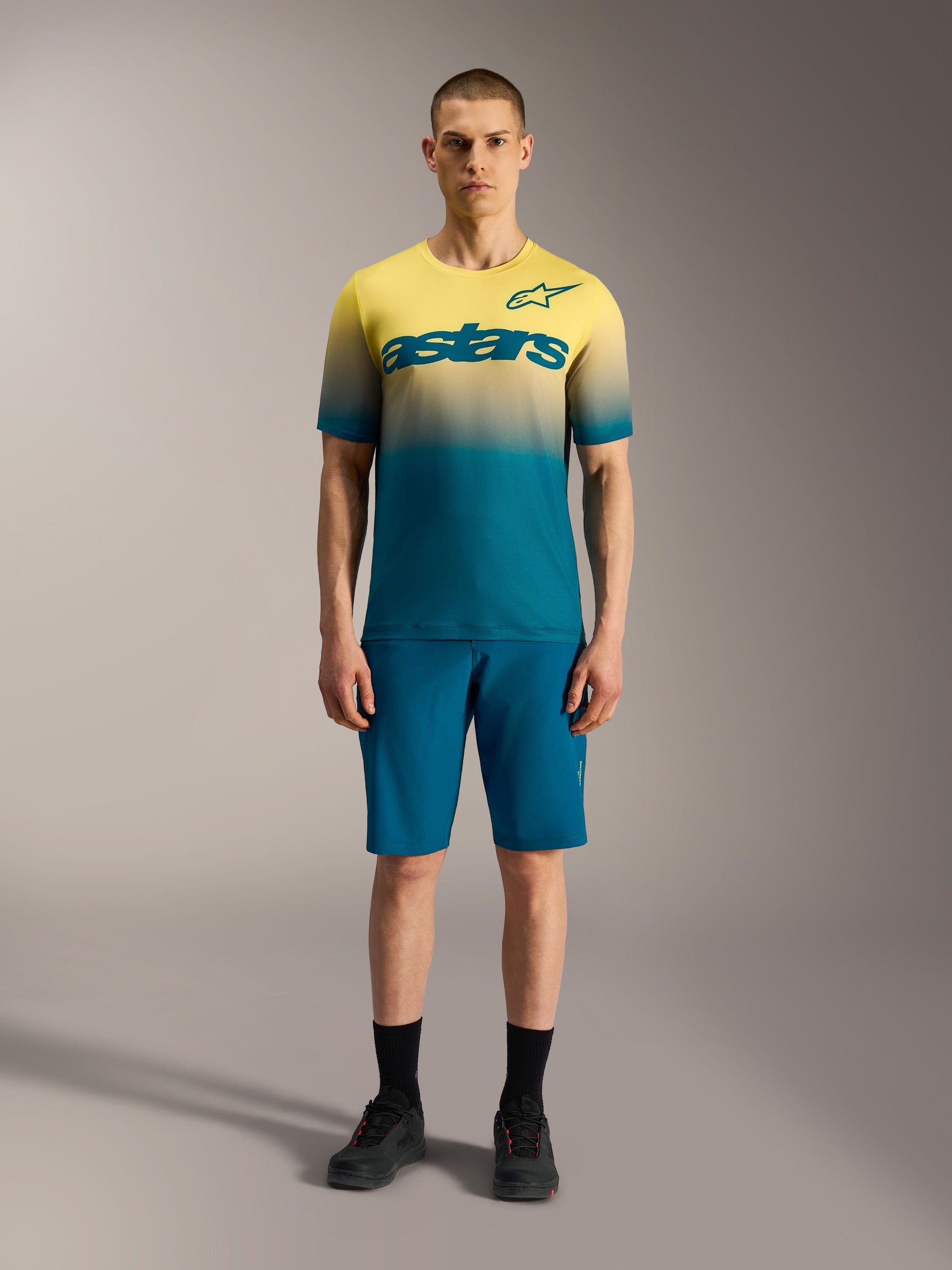 A-Dura ASTARS 2.0 Jersey, short sleeve MTB top featuring a yellow and blue gradient with a bold Alpinestars chest logo.