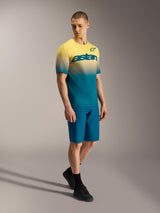 A-Dura ASTARS Jersey 2.0 with yellow to blue gradient, short sleeve MTB jersey featuring chest branding on a model.