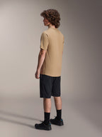 Alpinestars A-Dura Shorts, Mountain Bike Shorts, Black, paired with a tan A-Dura short-sleeve jersey and black riding shoes, featuring a regular fit and durable construction for off-road cycling, rear-side view