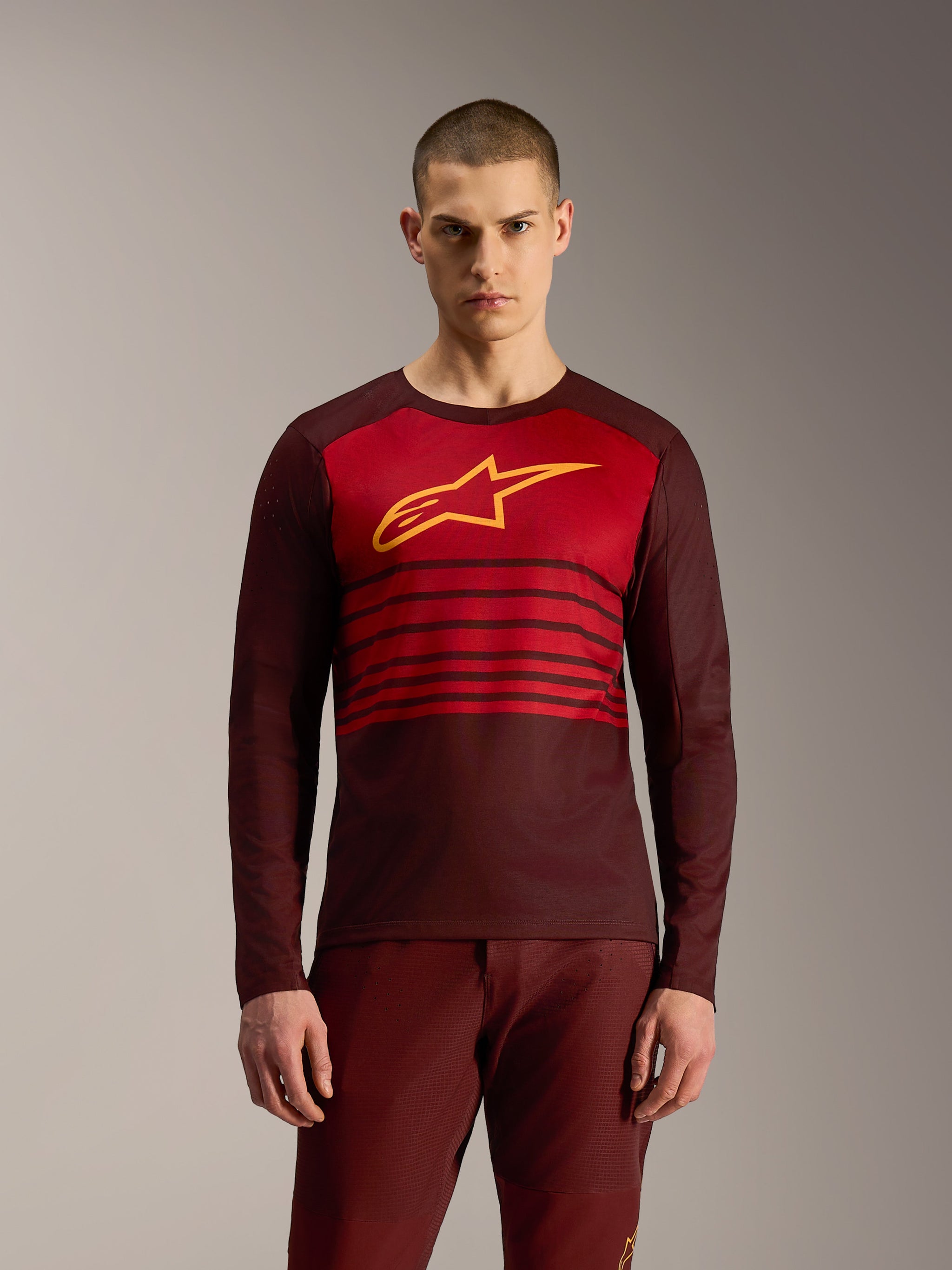 A-Dura Elite Long Sleeve Jersey 2.0 in Bordeaux red with horizontal stripes and yellow Alpinestars logo for MTB riding.
