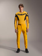 Limited Edition A-Supra Melt Gold Gear Set, Alpinestars Mountain Bike Apparel, Dark Yellow and Black, Model wearing long-sleeve jersey with bold 'astars' chest logo and matching performance pants, featuring laser-cut ventilation on inner thighs and a secure ratchet waist closure, professional MTB racing kit