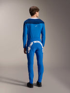 Male model seen from the back wearing the Alpinestars A-Supra Melt Long Sleeve Jersey in Blue, paired with matching blue performance pants featuring a large white Alpinestars wordmark across the back, complete MTB racing kit.
