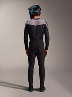 Alpinestars A-Supra Elite MTB kit in black, featuring performance pants and jersey with a full-face helmet, back view.