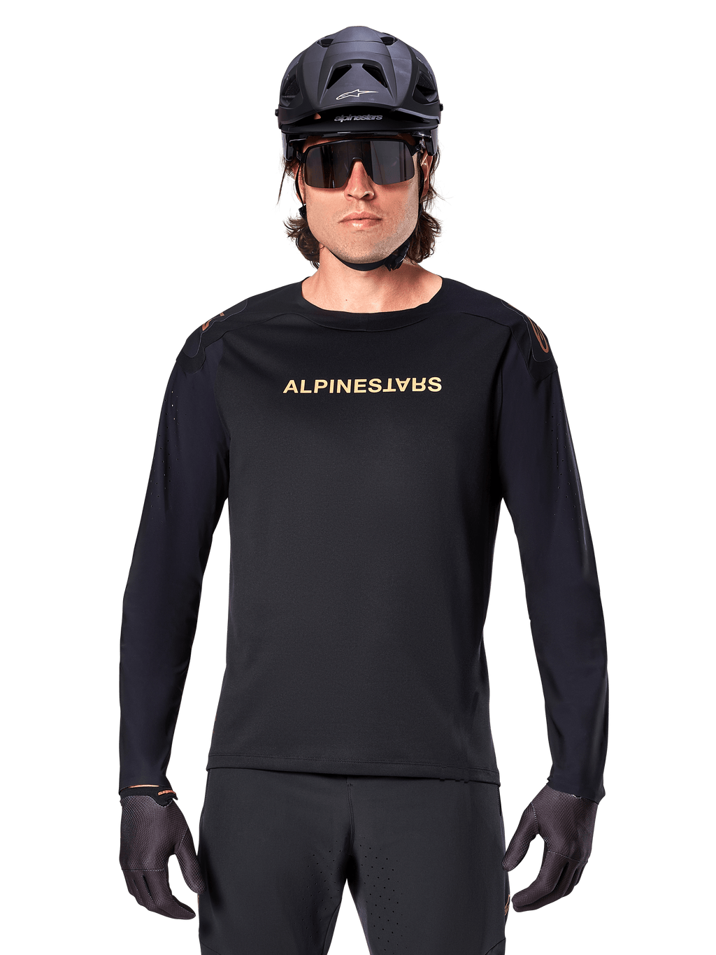 Alpinestars A-Aria Polartec Switch Long Sleeve Jersey, Black, gold Alpinestars logo on chest, worn with a black MTB helmet, dark sunglasses, and black gloves, professional mountain bike trail gear