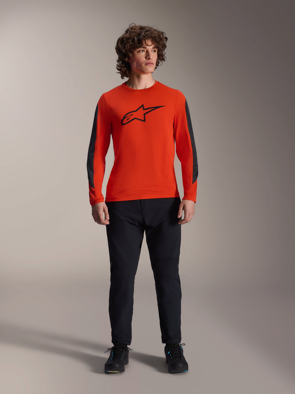 Alpinestars A-Dura Insert Astar Jersey - Long Sleeve, Spicy Orange with black Astar logo and dark grey sleeve panels, worn with black mountain bike pants and shoes, durable textile construction for off-road riding