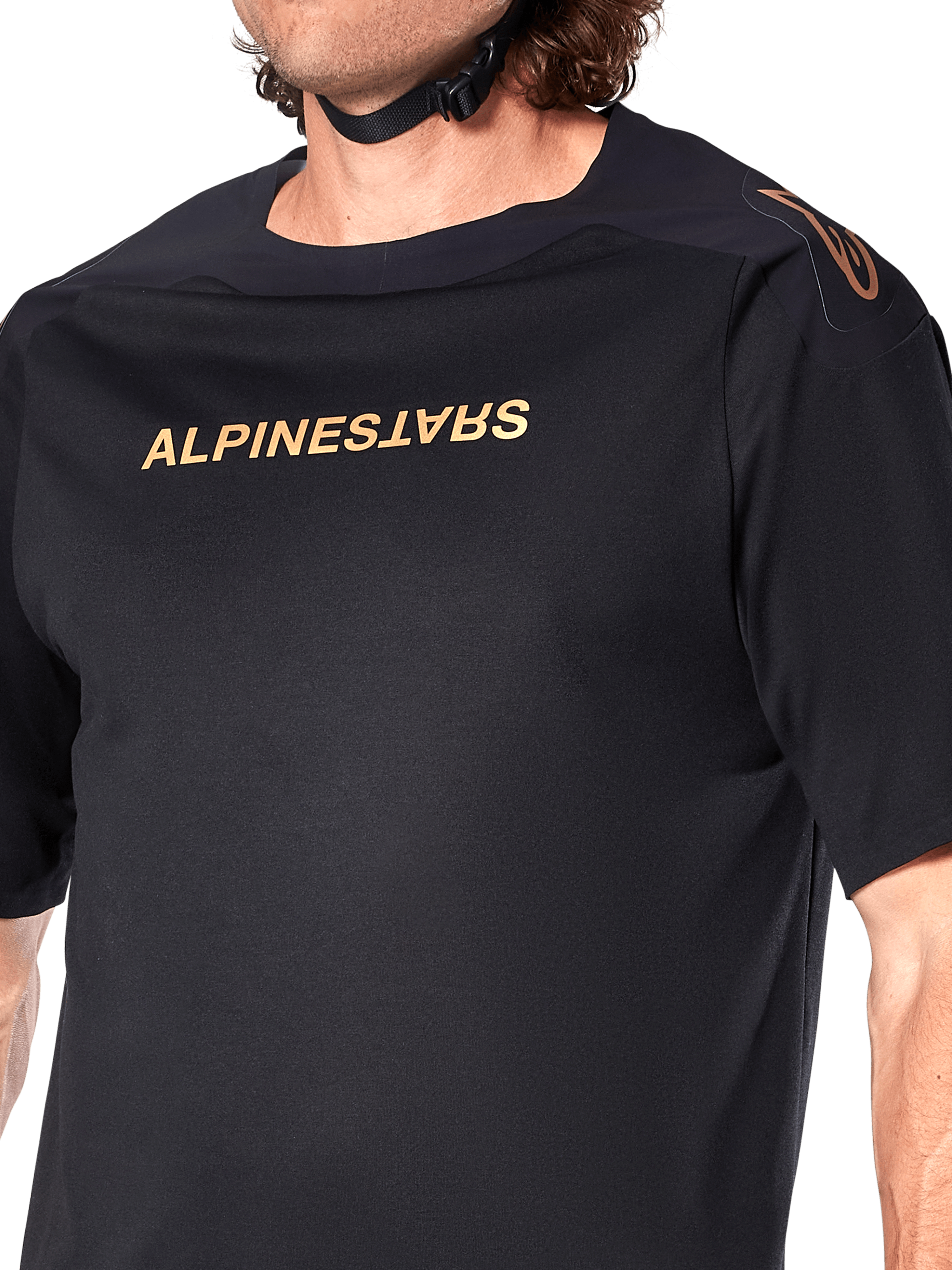 Alpinestars A-Aria Polartec Switch Jersey, Short Sleeve MTB Jersey, Black, Gold Alpinestars lettering on chest and logo on shoulder, close-up of the upper torso highlighting technical fabric and performance fit
