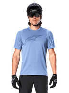 Male mountain biker wearing Alpinestars A-Dura Dri Astar Short Sleeve Jersey in Infinity Blue, featuring a subtle chest logo and mesh panels, paired with a black helmet, sunglasses, and black gloves for a technical cycling outfit