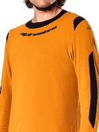 Alpinestars A-Dura Dri Wool Long Sleeve Jersey, Dark Gold, close-up showing black crew-neck collar with logo and black mesh ventilation panels on the shoulders and arms, high-performance mountain bike apparel