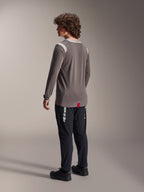 Alpinestars A-Dura Dri-Wool Long Sleeve Jersey in grey paired with A-Dura Elite Pants in black, rear view of model, featuring white Alpinestars logo on the leg, technical mountain bike gear for off-road riding