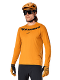 Alpinestars A-Dura Rocker Long Sleeve Jersey, MTB Mountain Biking Jersey, Dark Gold, person wearing jersey with matching helmet and gloves, sporty coordinated look with Alpinestars wordmark on chest