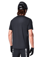 Alpinestars A-Dura Switch Jersey, Black men's short sleeve MTB jersey, rear view highlighting the drop tail and regular fit.