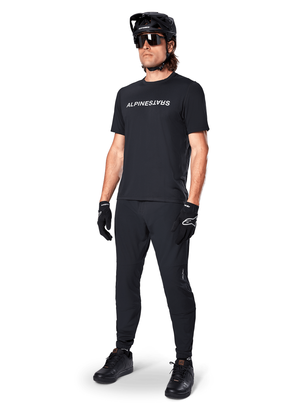 Alpinestars A-Dura Switch Jersey, Black short sleeve MTB top with white chest logo, worn by a male rider in full kit.