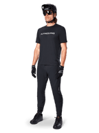 Alpinestars A-Dura Switch Jersey, Black short sleeve MTB top with white chest logo, worn by a male rider in full kit.