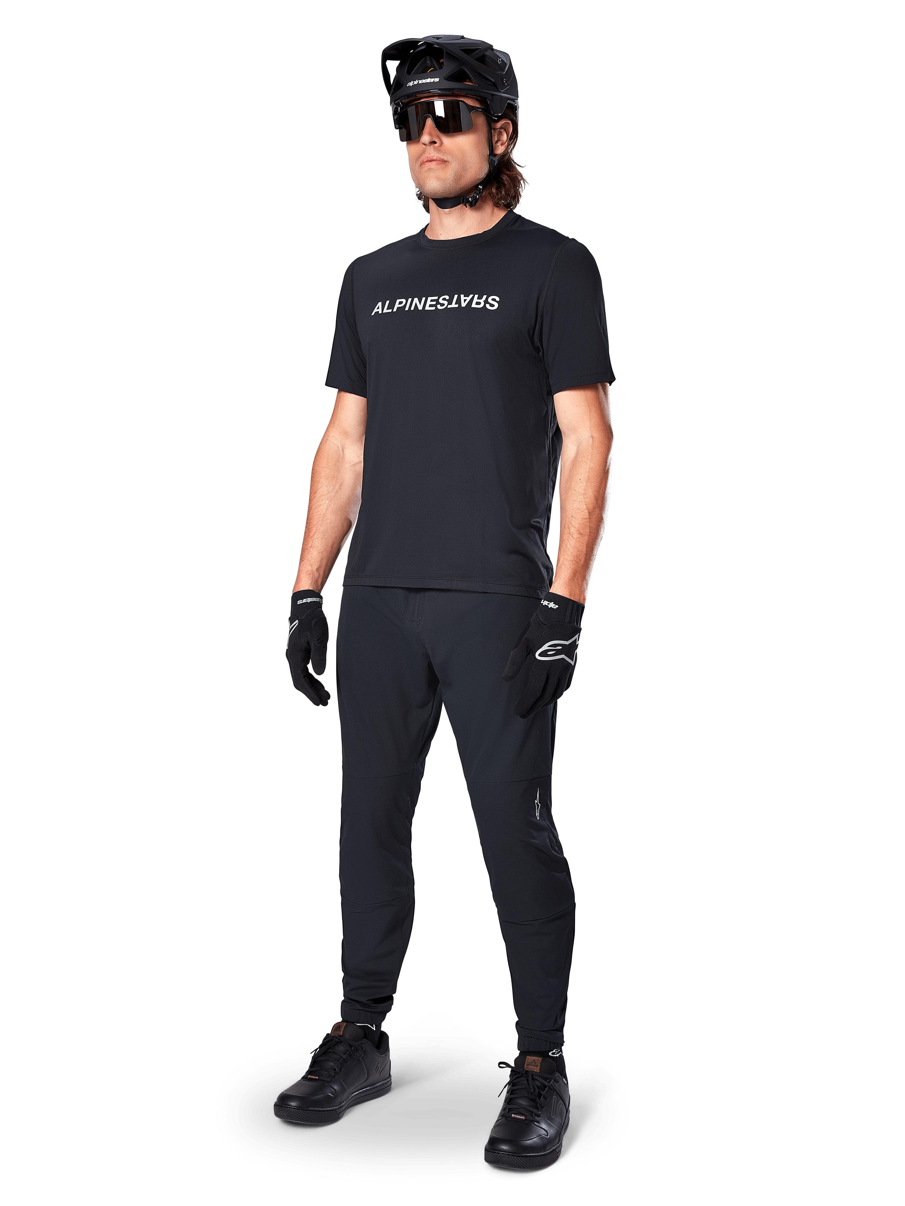Alpinestars A-Dura Switch Jersey, Black short sleeve MTB top with white chest logo, worn by a male rider in full kit.