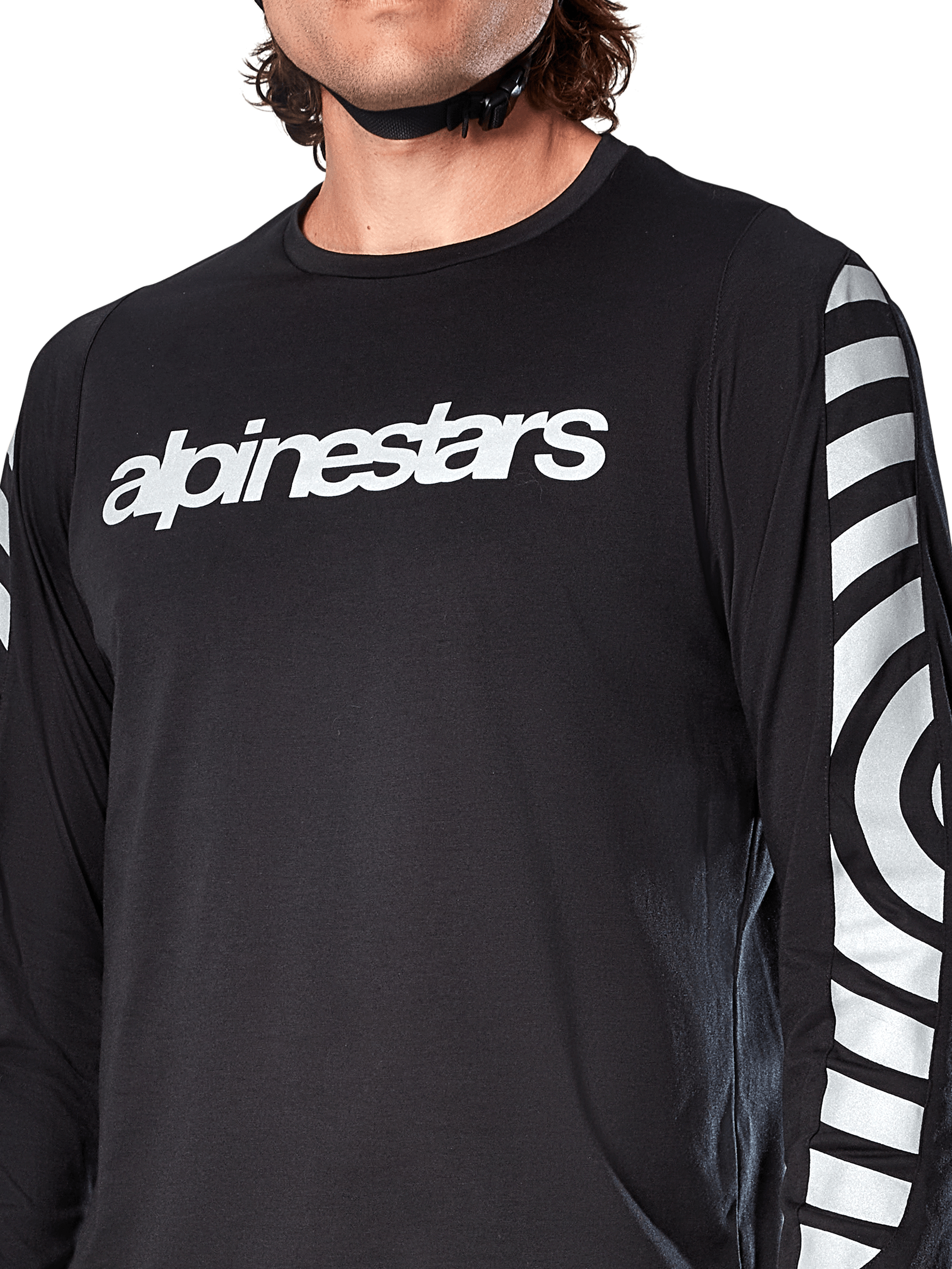 Alpinestars A-Dura Dri Oscar Long Sleeve Jersey, Black Reflective, close-up view showing white alpinestars logo on the chest and reflective circular graphics on the sleeves, technical cycling apparel for mountain biking