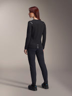 Alpinestars Woman Stella A-Dura Thermal Jersey, long-sleeve MTB jersey in Black, rear view showing reflective shoulder accents and extended drop tail, worn with black pants and shoes, performance gear for mountain biking.