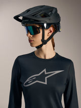 Black Women's Stella A-Dura Ride LS Jersey with grey Astars chest logo, worn with a matte black MTB helmet.