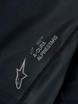 Black Stella A-Dura Ride Jersey close-up, showing technical jacquard fabric with A-DURA ALPINESTARS and Astars logos.