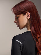 Alpinestars Stella A-Dura Thermal Jersey, Women's Long-Sleeve MTB Jersey, Black, close-up side view highlighting the reflective silver strip on the shoulder, technical insulated fabric for mountain biking
