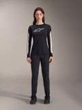 Alpinestars Women Stella A-Dura Pants, Black MTB Pants, featuring a dedicated women's fit with a streamlined design, paired with a black long-sleeve jersey and black cycling shoes, durable gear for off-road mountain biking