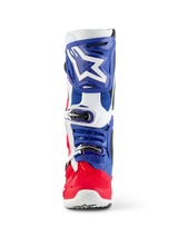 Alpinestars Limited Edition Fortitude Tech 10 Boot, Motocross Boot, Bright Red White and Blue, front view featuring a large white star logo on a blue shin plate, triple buckle closure system, and vibrant red foot shell, designed for elite off-road performance.