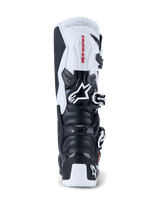 Alpinestars 2026 Tech 7 Enduro Boots, Motocross and Enduro Boots, Black and White, rear view showing TPU protective plates on the heel and calf, red Alpinestars branding on white upper panel, and silver buckle closure system, designed for high-performance off-road riding.