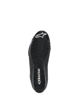 Alpinestars Celer Shoes, bottom sole view, black oil-resistant rubber compound with textured wavy grip pattern, featuring white Alpinestars branding on the toe and heel, designed for motorcycle footpeg traction.