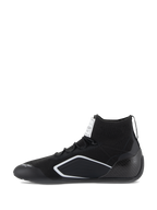 Alpinestars Supertech Shoes, Auto Racing Shoes, Black, side profile view featuring a knitted upper, carbon fiber heel cup, and white geometric accents, professional motorsport footwear