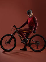 Bordeaux A-Dura Elite Jersey 2.0 and matching pants kit, worn by a mountain biker with a Specialized bike in a studio.